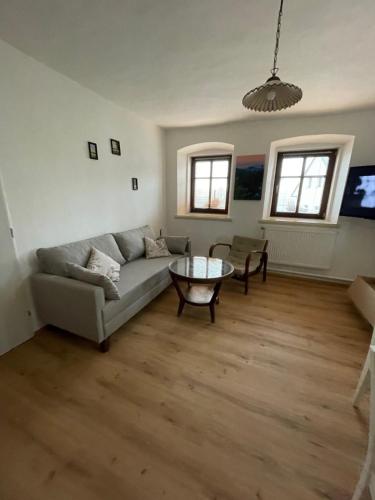 a living room with a couch and a table at Apartmán Eliška in Kuks