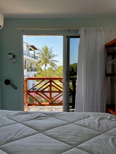 a bedroom with a bed and a view of a balcony at Victory Homes in Dar es Salaam