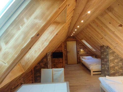 a bedroom in a log cabin with a bed at Noclegi u Banysia w sercu Gór Świętokrzyskich in Krajno Pierwsze