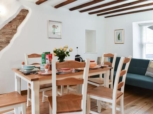 a kitchen and dining room with a wooden table and chairs at Summerville Cottage in Kirkby Stephen