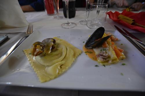 a white plate with some food on a table at Abas Ristorante Pizzeria Affittacamere in Ales