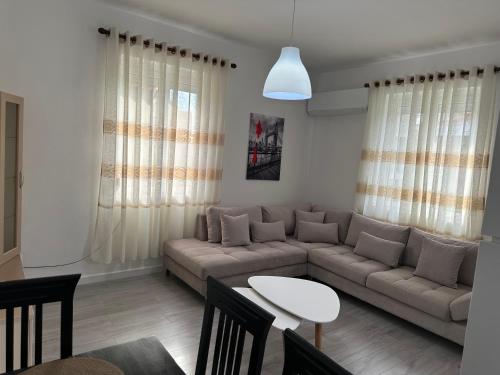 a living room with a couch and a table at Apartment Center Korça in Korçë