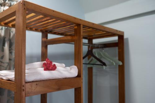 a wooden bunk bed with a red flower on top of towels at Victory Homes in Dar es Salaam