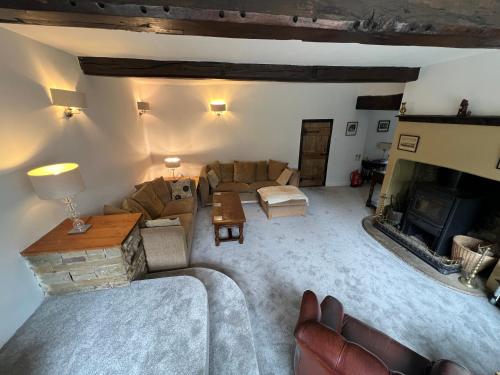 a living room with a couch and a fireplace at New Hall, Elland in Elland