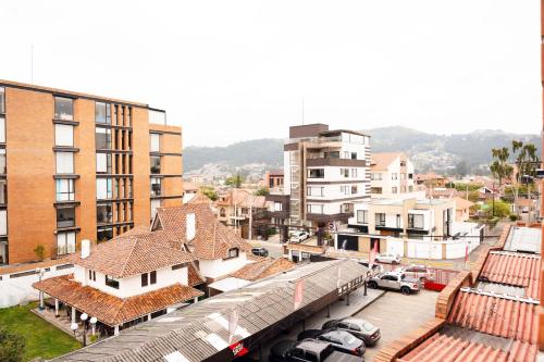 a train station in a city with buildings and cars at Dpto. San Andrés, la mejor vista y ubicación in Cuenca