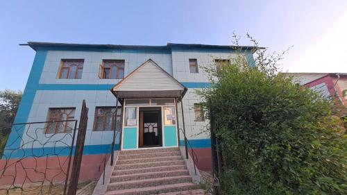 a building with a painting on the side of it at Econom house in Naryn