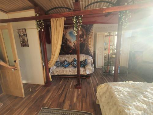 a bedroom with a canopy bed in a room at Baltā māja in Rīga