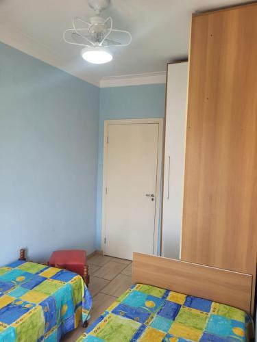 a bedroom with two beds and a closet at Sobrado na Cidade de Socorro in Socorro