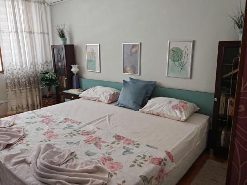 a bedroom with a large bed with two pillows at Guest House Plavas in Sozopol