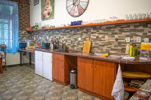 a kitchen with a counter and a clock on the wall at Penzion K in Rudník