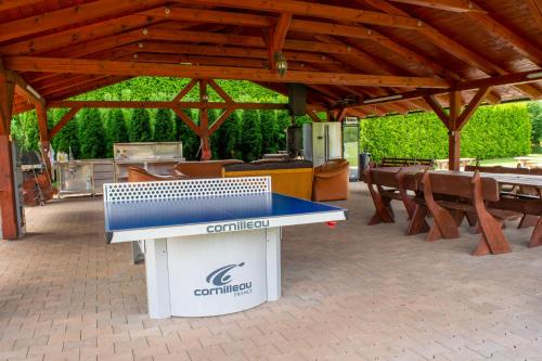 a ping pong table in front of a pavilion at Penzion K in Rudník