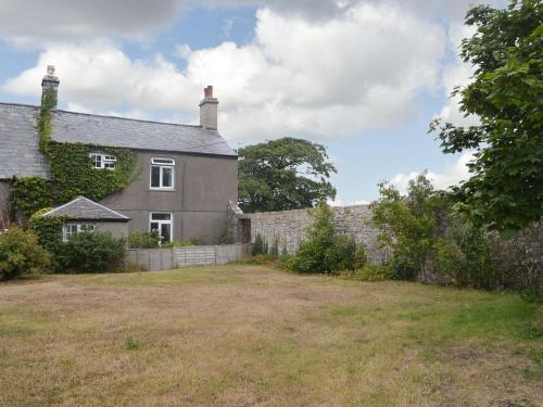 an old house with a yard in front of it at East Monkton Farm Cottage in Wick