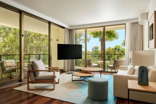 a living room with a couch and a tv at Marriott Residences Salgados Resort, Algarve in Albufeira