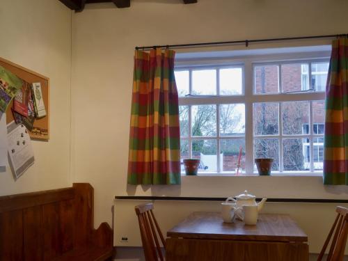 a dining room with a table and a window at Swiss Cottage - E5375 in Alrewas