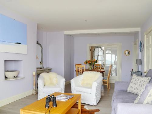 a living room with a couch and chairs and a table at Seashore Apartment in Sandgate