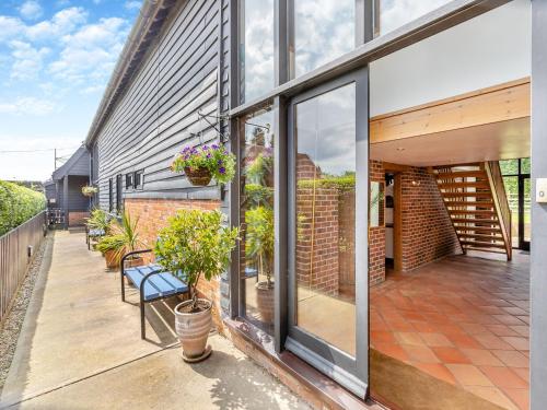 an extension to a house with sliding glass doors at Clamp Farm Barn in Stowmarket