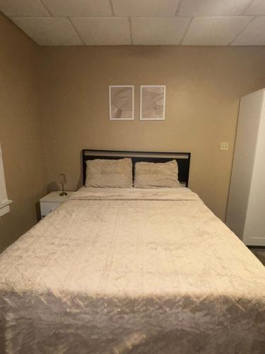a bedroom with a large bed with two pillows at Carepoint Residence in Lawnside