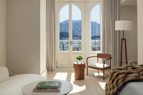 a living room with a couch and a table and a window at The Lake Como EDITION in Griante Cadenabbia
