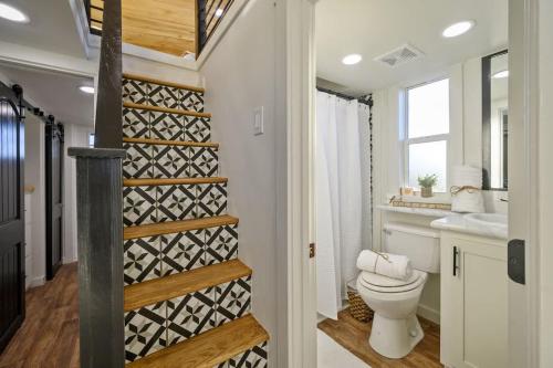 a small bathroom with a toilet and a sink at Shadowrock - Luxury Tiny Home with Amazing Views in Yanush