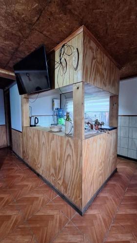 a kitchen with a counter with a television in it at Parcela Vista Hermosa in Lonquimay