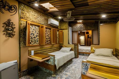 a room with two beds and a sink in it at Tita Tati Disconnect near Cartagena in Punta Canoas