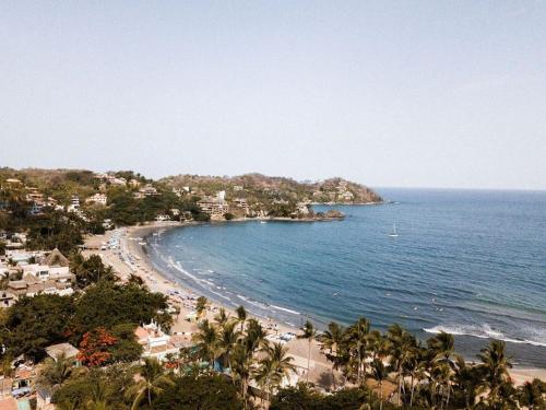 a view of a beach with palm trees and the ocean at Florence Sayulita in Sayulita