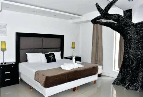 a bedroom with a bed with a tree on it at Mayafair All Inclusive in Cancún