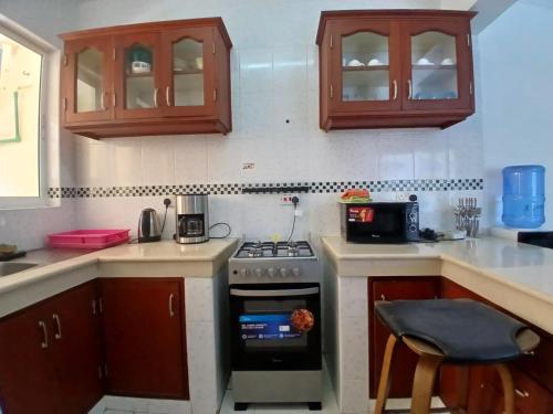 a kitchen with a stove and a counter top at Ary Homestay Nyali - Next to Nyali Center in Mombasa