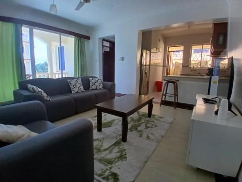 a living room with a couch and a table at Ary Homestay Nyali - Next to Nyali Center in Mombasa