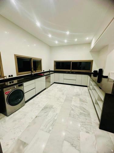 a large room with a washer and dryer at Villa Itran Marrakech in Aguelmous