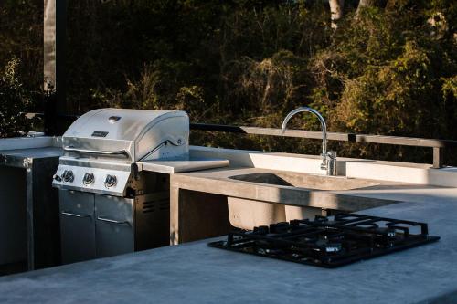 a kitchen with a sink and a stove at Florence Sayulita in Sayulita