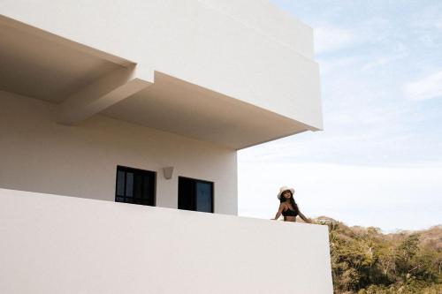 a person standing on the edge of a building at Florence Sayulita in Sayulita