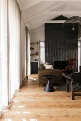 a living room with a couch and a table at Tide and Timber Luxury Guesthouse in Hermanus