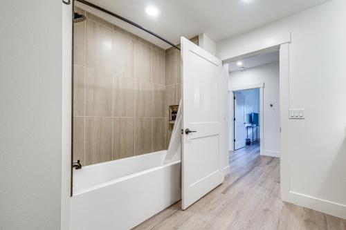 a bathroom with a shower and a white door at Suncadia Resort Condo Near Trails and River Access! in Cle Elum