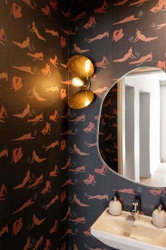 a bathroom with a mirror and a sink at Tide and Timber Luxury Guesthouse in Hermanus
