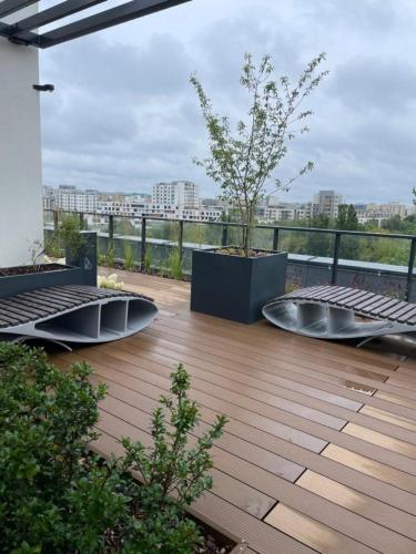 a deck with a tree on top of a building at Green Airport Apartment in Warsaw