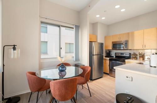 a kitchen with a table and chairs in a kitchen at The Sunstone - Full Oceanview Right On The Sand in Los Angeles