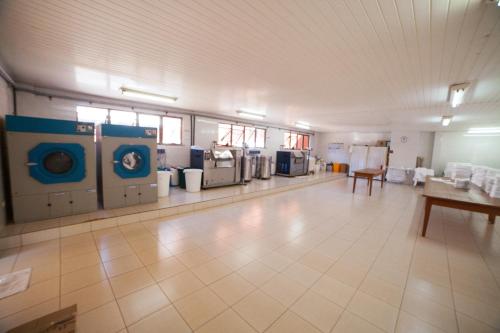 a large room with several washing machines in it at Copas Executive Hotel in Cascavel