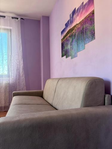 a living room with a couch and a window at Casale dei Gelsomini - Country House in Poggio