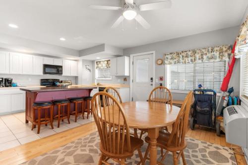 a kitchen and dining room with a table and chairs at Stay Steps from Beach with Pool AC Parking in Hampton
