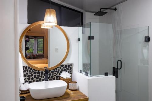 a bathroom with a sink and a mirror at ECOTICA Boutique Hotel in Manuel Antonio