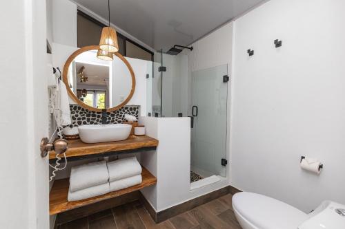 a bathroom with a sink and a mirror at ECOTICA Boutique Hotel in Manuel Antonio
