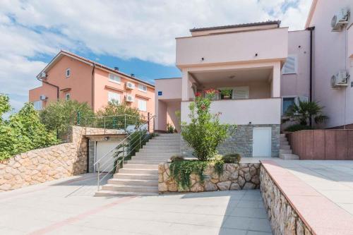 a house with stairs in front of a building at Apartments in Klimno - Insel Krk 13574 in Klimno