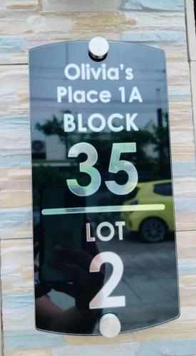 a sign on a building with a price for a bus at 1A - Cabanatuan City's Best Bed and Breakfast Place in Bantug