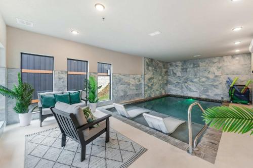 a pool in a living room with furniture and a table at Smith Creek Resort - 5 Bedrooms 20 Guest - Indoor Pool - Resort Amenities in Pigeon Forge