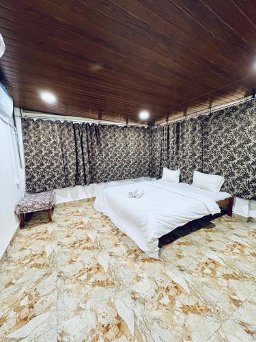 a bedroom with a large bed with a stone floor at Tony apartment baga in Baga