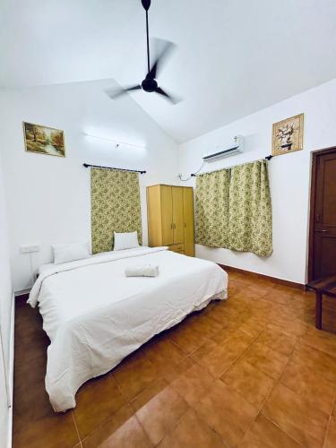 a bedroom with a large bed and a ceiling fan at Tony apartment baga in Baga