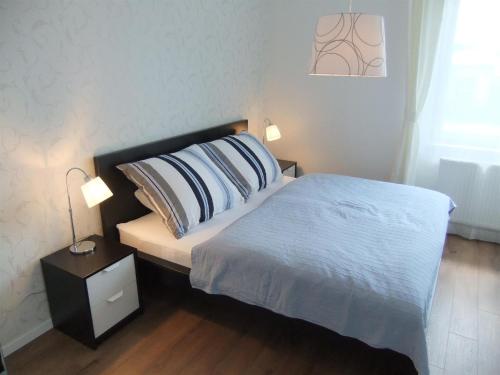 
Un pat sau paturi într-o cameră la ELEGANT apartmán ajaj
