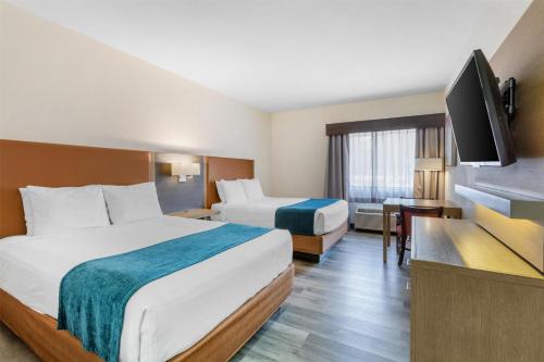 a hotel room with two beds and a flat screen tv at Best Western Inn of Payson in Payson