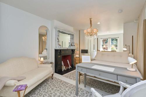 a living room with a couch and a fireplace at Private DC Retreat on Iconic East Capitol St in Washington, D.C.